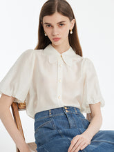 A lady wears a puff-sleeved shirt.